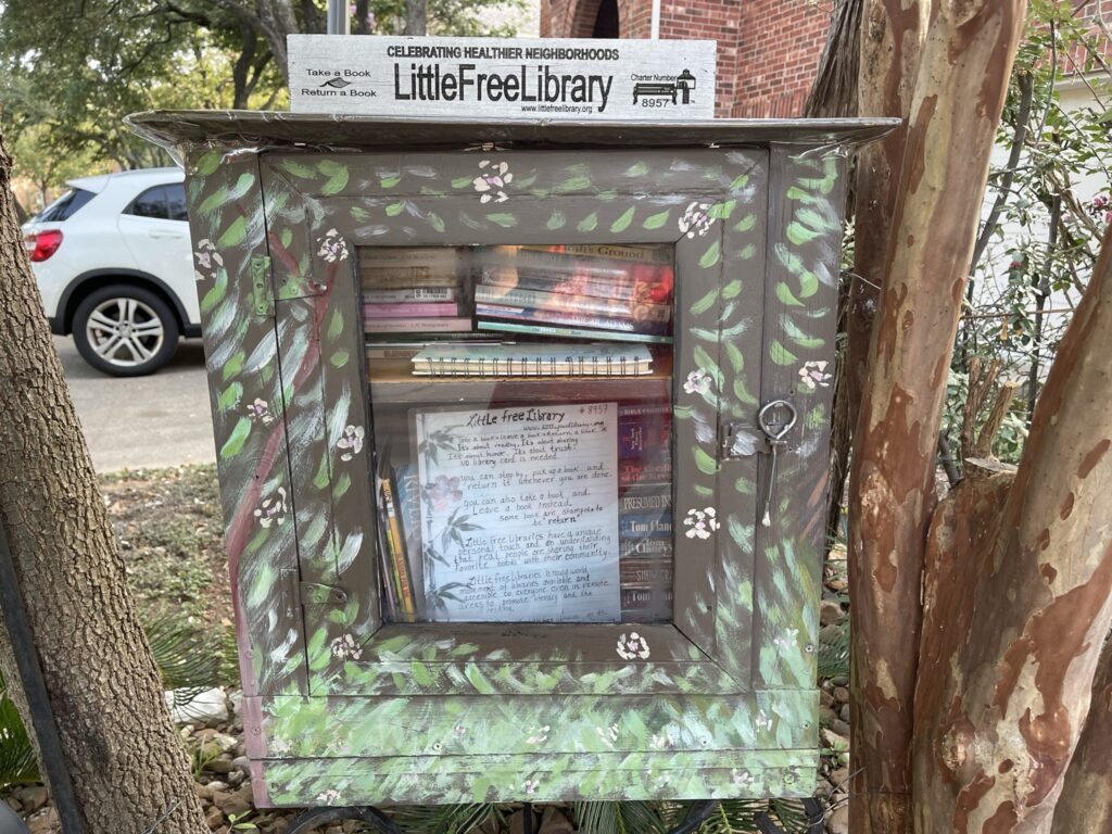 A picture of a free little library in a neighborhood. 
